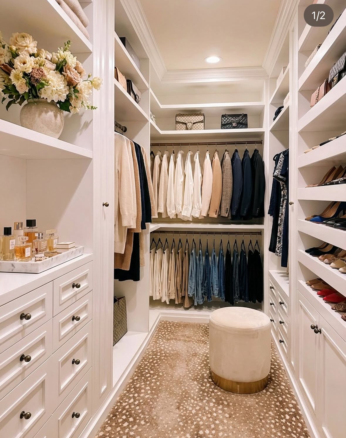 Beautifully organized white walk-in closet with curated wardrobe